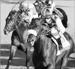  ?? COADY PHOTOGRAPH­Y ?? Ivar, with Joe Talamo riding, wins the Shadwell Turf Mile. It was the first Grade 1 win for Talamo’s agent, Rocco O’Connor.