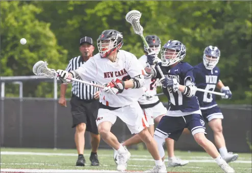  ?? Dave Stewart / Hearst Connecticu­t Media ?? New Canaan’s Justin Wietfeldt (33) wins a faceoff while Wilton’s Cole Stephenson (17) pursues during the CIAC Class L boys lacrosse quarterfin­als at Dunning Field in New Canaan on Saturday.