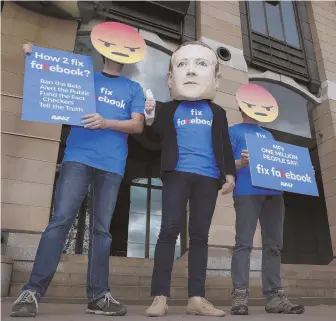  ?? APPhOTOS ?? MAD: A protester wears a mask with the face of Facebook founder Mark Zuckerberg in between men wearing angry-face emoji masks during a protest yesterday in London against Facebook.