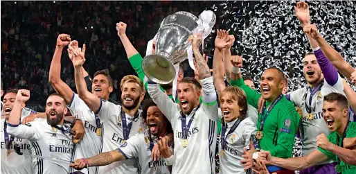  ?? AFP ?? Real Madrid become the first team to repeat as European champion since AC Milan accomplish­ed the feat in 1989-1990. —