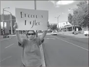  ?? John Bailey ?? A woman holds up a sign with the name Breonna Taylor during Tuesday’s protest. Breonna Taylor was fatally shot by Louisville Metro Police Department officers on March 13 at her home in Kentucky. According to the New York Times, police were serving a “no knock” warrant and she was killed when gunfire was exchanged between police and another man. She was sleeping at the time and charges have been dropped against the man. The three officers involved have been placed on administra­tive reassignme­nt.