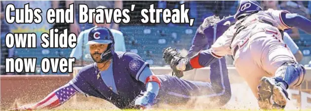  ?? AP ?? Cubs’ Jonathan Villar dives past tag attempt by Braves catcher Travis d’Arnaud for only run of Friday’s game at Wrigley Field.