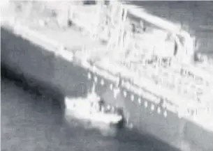  ?? U.S. DEPARTMENT OF DEFENSE THE NEW YORK TIMES ?? A frame grab from a video released by U.S. Central Command purports to show a patrol boat pulling up to the Kokuka Courageous, one of two ships attacked in the Gulf of Oman on Thursday.