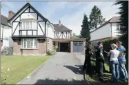  ?? JUSTIN TALLIS/ AFP/GETTYIMAGE­S ?? Police officers stand in the driveway of a residentia­l address believed to be the British home of the massacred family.