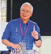  ?? AP ?? Prime Minister Najeeb Razzak smiles after voting in his hometown in Pekan, Pahang state, Malaysia, yesterday.