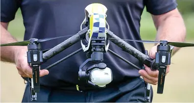  ??  ?? Hi-tech: An officer with a drone, in police livery and equipped with a high-resolution camera