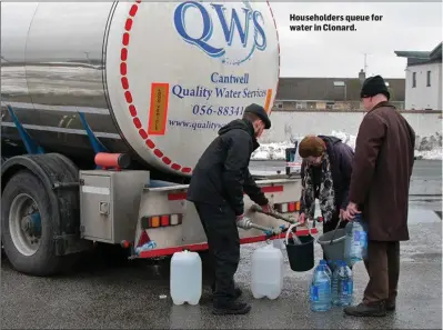  ??  ?? Householde­rs queue for water in Clonard.