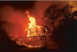  ?? Josh Edelson AFP/Getty Images ?? A HOME burns in the Spanish Flat community of Napa on Aug. 18, one of several wildfires that would eventually merge to form the LNU Lightning Complex fire.