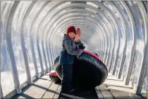  ?? SUGAR BOWL RESORT ?? A covered moving carpet ride takes guests up to the top of the tubing lanes at Sugar Bowl's new Sugar Rush Tubing venue.