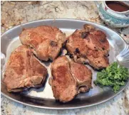  ?? RICK WOOD / MILWAUKEE JOURNAL SENTINEL ?? Stuffed veal chops are served with a sauce that includes dry red wine and homemade veal stock.