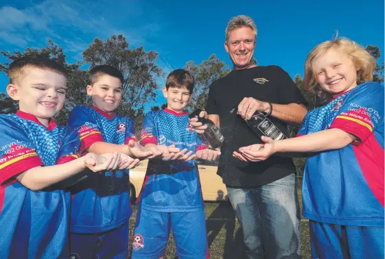  ?? Picture: GLENN HAMPSON ?? David Ridden deals out the hand sanitiser for Robina players (from left) Lucas Foweraker, Isaac Foweraker, Bill Barber and Logan Schoor.