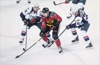  ?? JULIE JOCSAK
THE ST. CATHARINES STANDARD ?? Niagara’s Kirill Maksimov, shown being double-teamed by Windsor, has been invited to join the Russian national junior team for a series of exhibition games.