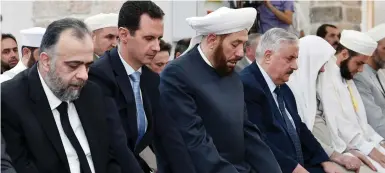  ?? (SANA) ?? SYRIAN PRESIDENT Bashar Assad (2nd L) attends prayers in a mosque in Hama on the first day of Eid al-Fitr, in this picture provided by the Syrian Arab News Agency on Sunday.