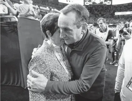  ?? DAVID J. PHILLIP/AP ?? Duke coach Mike Krzyzewski hugs his wife, Mickie, after Duke lost, 81-77, to North Carolina in the Men’s Final Four on Saturday night in New Orleans.