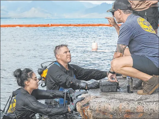  ?? Lance Cpl. Hunter Jones
The Associated Press ?? This photo provided by the U.S. Marine Corps, U.S. Navy Sailors with Mobile Diving and Salvage Unit 1 retrieve an aircraft flight recorder from a downed U.S. Navy plane in Kaneohe Bay at Marine Corps Base Hawaii on Thursday.