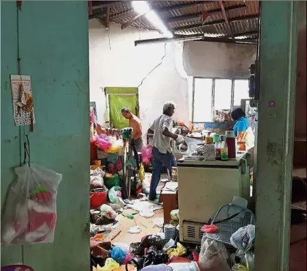  ??  ?? Moving home: Residents in Hong Seng Estate packing their things at their house before the authoritie­s can move in to carry out the ground structure stabilisin­g work.