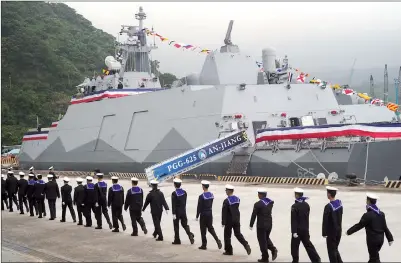  ?? PHOTO: SAM YEH, AFP ?? Navy sailors walk past a Taiwan-made corvette during its inaugurati­on ceremony at Suao Harbor in Yilan County yesterday.