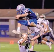  ?? Adam Dortch ?? Gordon Central’s Brison McGinnis leaps over a Pepperell defender on Monday night.