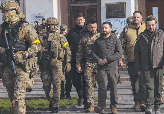  ?? Picture: Getty ?? President Volodymyr Zelensky (third from right) makes a flying visit to Kherson to congratula­te the troops who liberated the city.