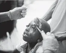  ?? DIEU NALIO CHERY THE ASSOCIATED PRESS ?? A boy injured by an aftershock receives treatment at the hospital in Port-de-Paix. The aftershock struck on Sunday, even as survivors of the previous day’s quake were sifting through the rubble of their homes.