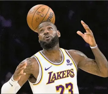  ?? Ashley Landis Associated Press ?? LeBRON JAMES, who scored 40 points, dished out nine assists and grabbed eight rebounds, loses control of the ball during the Lakers’ 128-121 loss to the Golden State Warriors on Saturday at Crypto.com Arena.