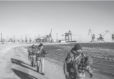  ?? MARTYN AIM / GETTY IMAGES ?? Soldiers with Ukraine’s border security force patrol the coast of the Azov Sea near the port of Mariupol on Thursday. U.S. President Donald Trump called off a meeting with Russian President Vladimir Putin at the G20 summit in Argentina because of Russia’s recent hostilitie­s with Ukraine.