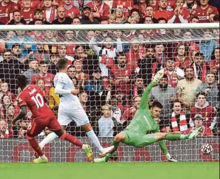  ?? EPA PIC ?? Liverpool’s Sadio Mane (left) scores their second goal against Burnley in yesterday’s Premier League match at Anfield. Liverpool won 2-0.