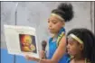  ?? ERIC BONZAR — THE MORNING JOURNAL ?? Thirteen-year-old Niyere Chambers, member of the African Royalty Dancers, recites the meaning of Kwanzaa.