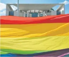  ?? John MacDougall, AFP/Getty Images file ?? Activists stretch a giant rainbow banner in front of the Chanceller­y in Berlin during an April 30 demonstrat­ion calling on Russian President Vladimir Putin to end the persecutio­n of gay men in Chechnya.