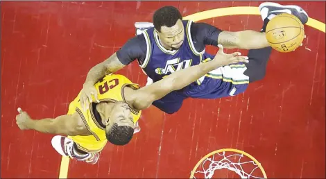  ??  ?? Utah Jazz forward Trevor Booker (right), shoots against Cleveland Cavaliers center Tristan Thompson during the first half of an NBA basketball game on Nov 10,
in Cleveland. (AP)