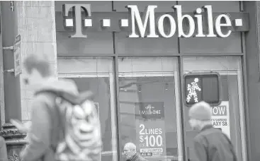  ?? Justin Sullivan / Getty Images ?? There is a great deal of pressure on Sprint to make a deal with T-Mobile, which operates this store in San Francisco. T-Mobile said Monday it will add 2.8 million to 3.5 million customers this year.