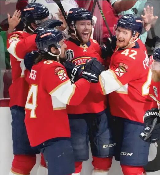  ?? REBECCA BLACKWELL/AP ?? On Thursday, Carter Verhaeghe (second from right) was the latest Panther to score a game-winning goal in overtime.