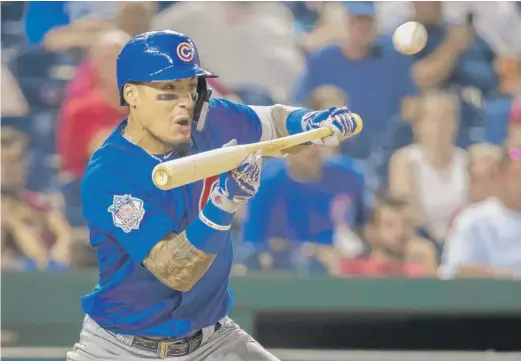  ?? SCOTT TAETSCH/GETTY IMAGES ?? Javy Baez drives in the go-ahead run with a bunt in the 10th inning against Washington in the makeup game at Nationals Park on Thursday.