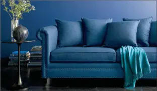  ?? Crate & Barrel ?? A blue, upholstere­d sofa from Crate & Barrel. Deep, rich blues are trending across all the decor categories this fall. Furniture like this sofa in a warm navy hue bring coziness home for the cooler months.