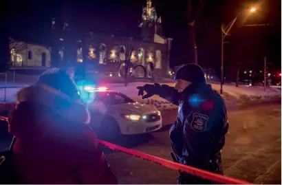  ?? Reuters ?? A Canadian police officer talks to a woman after the shooting in a mosque at the Quebec City Islamic cultural centre. —