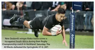  ??  ?? New Zealand’s winger Rieko Ioane scores a try against South Africa during their Rugby Championsh­ip match in Auckland Saturday. The All Blacks defeated the Springboks 57-0. (AP)