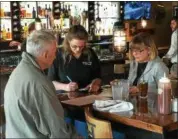  ?? CHAD FELTON — THE NEWS-HERALD ?? Server Maureen Hildebrand­t attends to patrons at Smokin’ Q’s BBQ and Beer House on June 5. The new restaurant, owned by Carl Quagliata, opened this week in the former Fisher’s Tavern location.