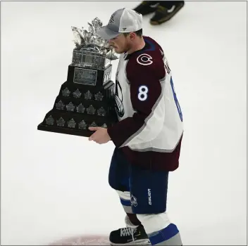  ?? ?? Colorado Avalanche defenseman Cale Makar skates with the Conn Smythe Trophy for being the playoff MVP.