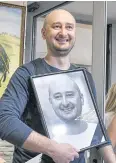  ?? AFP ?? Arkady Babchenko holds a portrait his colleagues displayed in his memory.