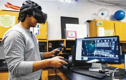  ?? Eli Hartman / Odessa American ?? Senior Octavio Garcia, 17, demonstrat­es their research within a program called Syglass using a Steam VR headset at New Tech Odessa. The class has partnered with the University of South Florida on the research.