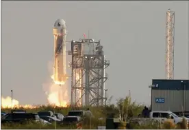  ?? TONY GUTIERREZ — THE ASSOCIATED PRESS ?? Blue Origin’s New Shepard rocket launches carrying passengers Jeff Bezos, founder of Amazon and space tourism company Blue Origin, his brother Mark Bezos, Oliver Daemen and Wally Funk, from its spaceport Tuesday near Van Horn, Texas.