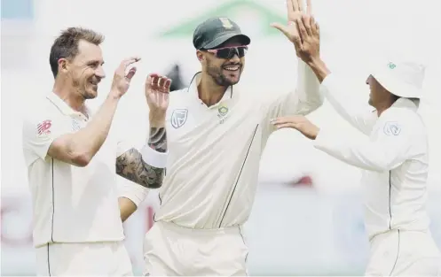  ??  ?? 0 South Africa’s Dale Steyn, left, Aiden Markram and Zubayr Hamza celebrate taking the wicket of Sri Lanka’s Kusal Perera.