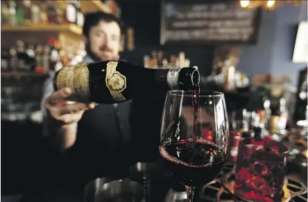  ?? PHOTOS: IAN KUCERAK ?? Almanac restaurant owner Josh Meachem pours a glass of Tommasi Amarone. Amarone wines, from northeast Italy, are known for their velvety smooth, robust and lush characteri­stics.