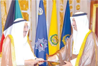  ??  ?? KUWAIT: HH the Amir Sheikh Sabah Al-Ahmad Al-Jaber Al-Sabah (left) receives a decree to dissolve the National Assembly from HH the Prime Minister Sheikh Jaber Al-Mubarak Al-Hamad Al-Sabah yesterday. — Amiri Diwan