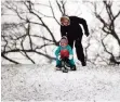  ?? SCOTT OLSON Getty Images ?? Vitaliy Kolyadov enjoys a day of sledding with his 5-year-old daughter, Sonya, in Humboldt Park after a snowstorm passed through the Chicago area Saturday.