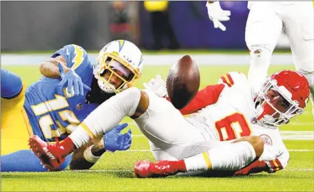  ?? Robert Gauthier Los Angeles Times ?? CHARGERS RECEIVER Keenan Allen (13) and Chiefs safety Bryan Cook watch the ball after Allen fumbled in the fourth quarter.