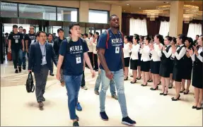  ?? YONHAP VIA REUTERS ?? Members of the ROK men’s basketball team are greeted by employees upon their arrival at Koryo