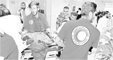  ??  ?? A handout picture released by the official Syrian Arab News Agency (SANA) shows a wounded man arriving at a hospital in Damascus, after rockets fired from Douma killed at least four civilians in various neighbourh­oods across the capital. — AFP photo