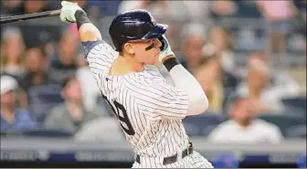  ?? Mike Stobe / Getty Images/TNS ?? Aaron Judge of the New York Yankees hits his second home run of the game in the fifth inning against the Chicago Cubs at Yankee Stadium on Saturday in New York. Judge extended his major-league lead in home runs to 24 for the season.