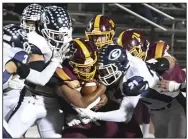  ?? (The Sentinel-Record/Grace Brown) ?? The Greenwood defense gang-tackles Lake Hamilton running back Tevin Woodley on Friday during the Bulldogs’ 38-28 victory over the Wolves in Pearcy.